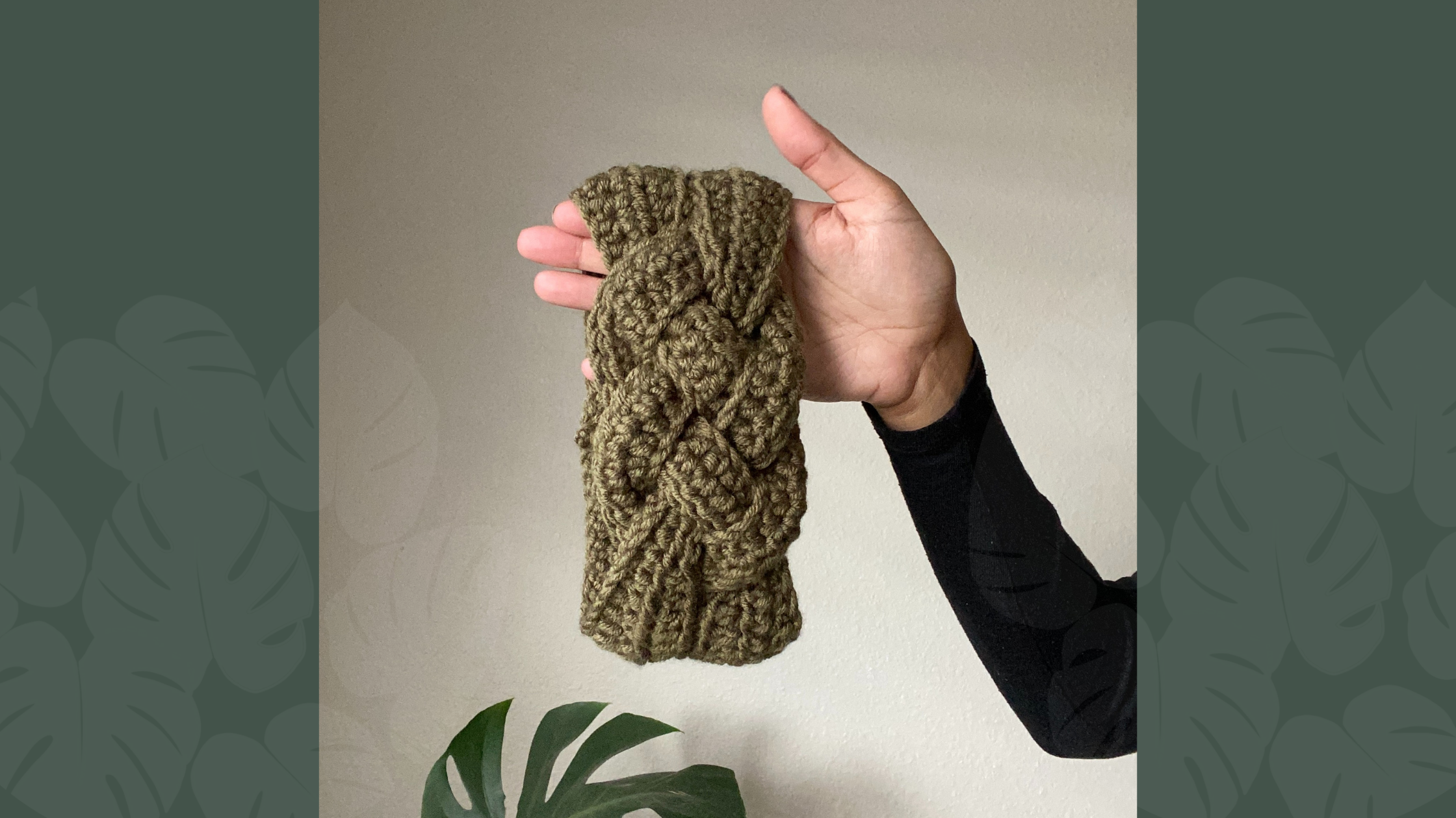 olive sailor's knot headband being held in front of houseplant