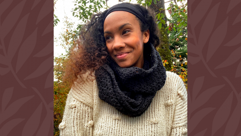 model looking to side wearing crochet cowl scarf