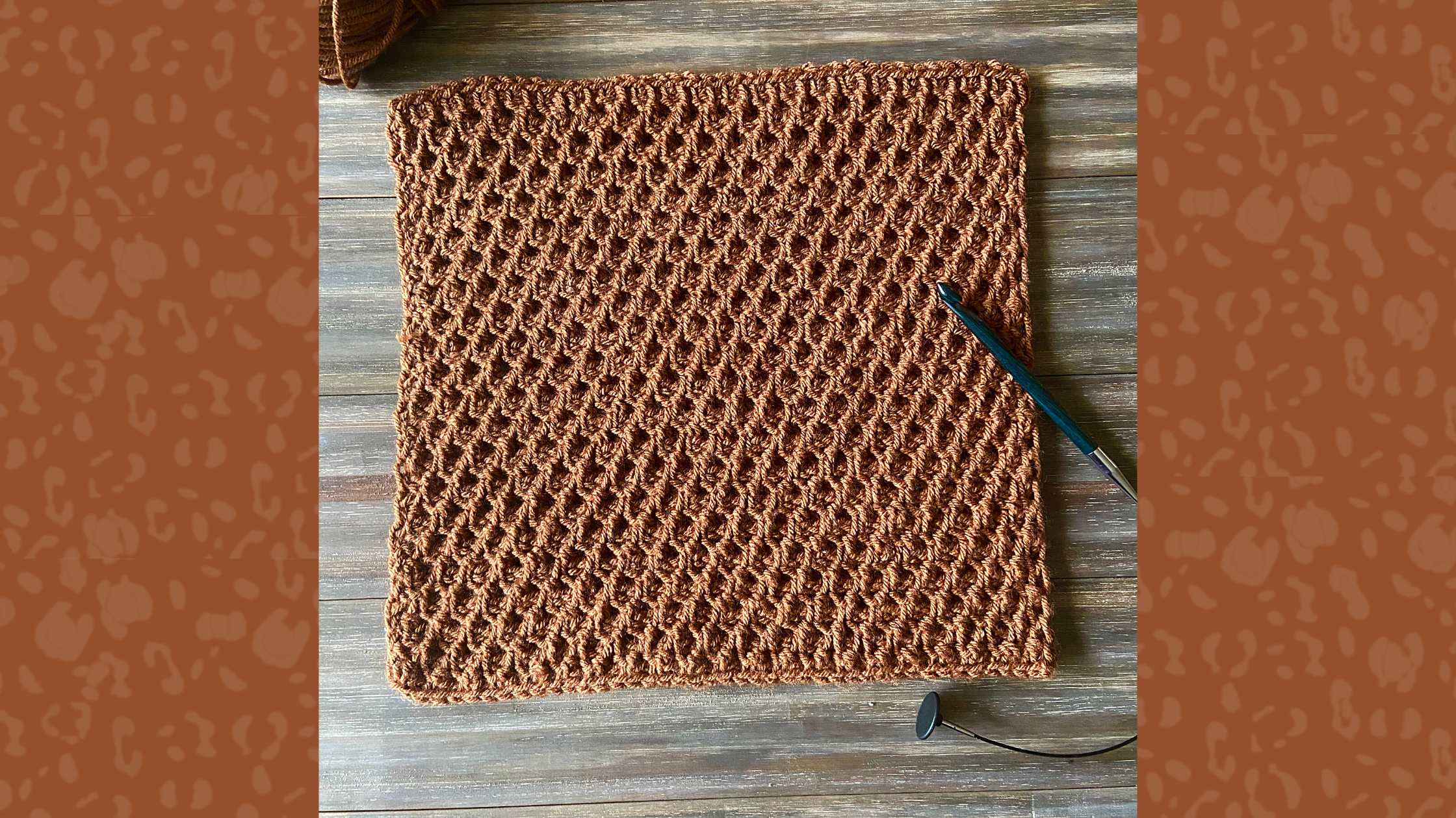 brown tunisian crochet blanket square on wood background with crochet hook on top