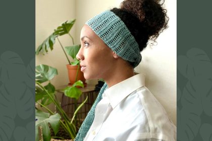side profile of model with curly bun wearing blue hair scarf