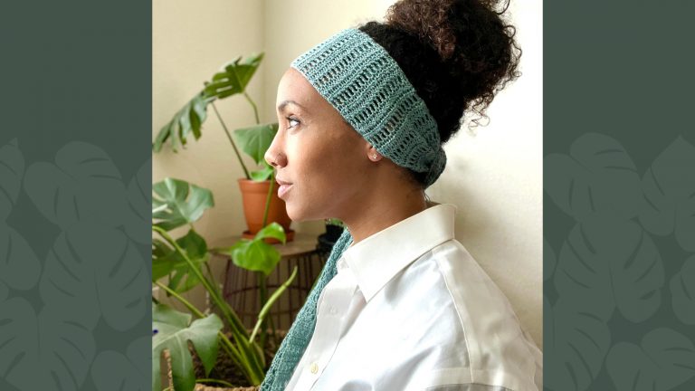 side profile of model with curly bun wearing blue hair scarf