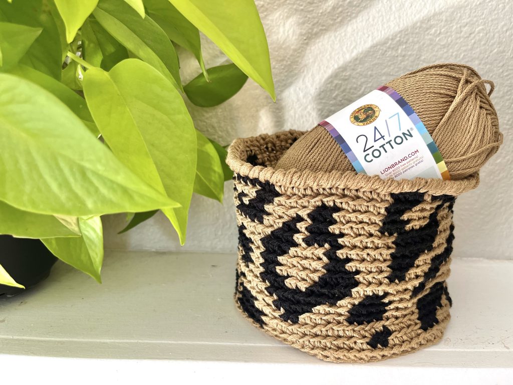 leopard basket holding skein of 24/7 cotton yarn