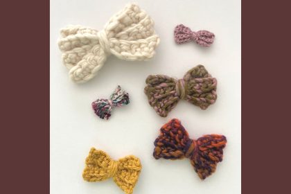 six crochet bows in various colors and sized on white background