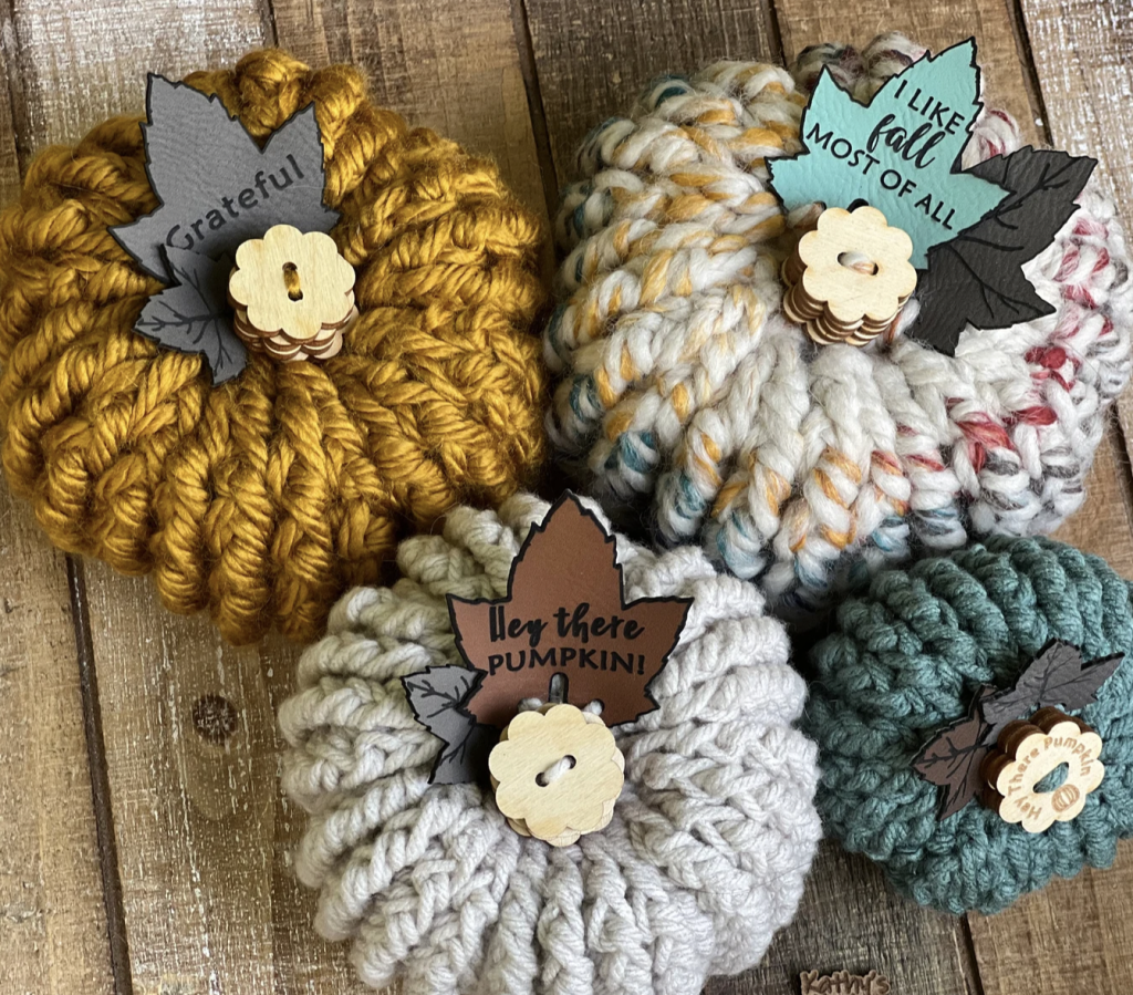 small multi color crochet pumpkins with wood buttons for stems